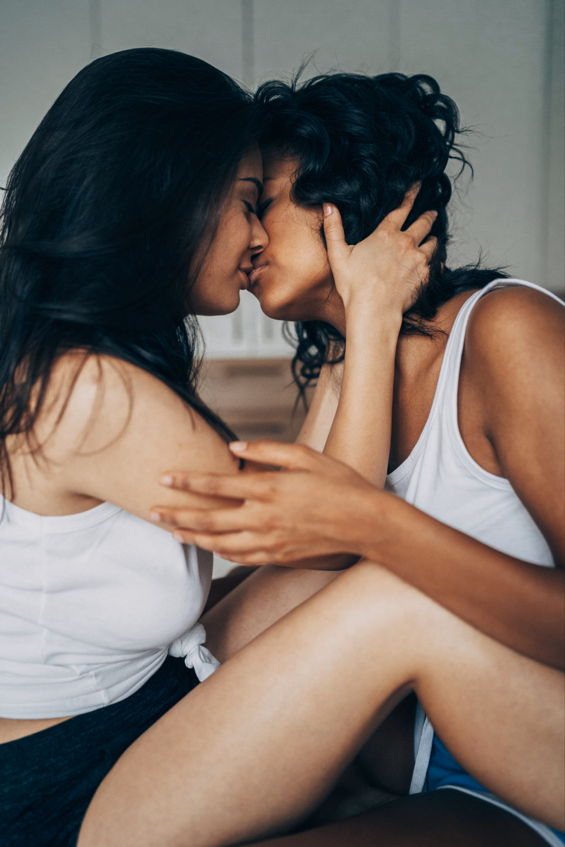 Zwei Frauen, eng und intim miteinander umschlungen, küssen sich